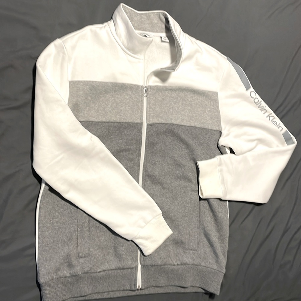 Dark gray, light gray and white Calvin Klein jacket. Like new - worn once.